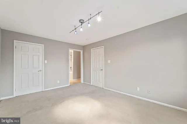 a view of an empty room and a ceiling fan