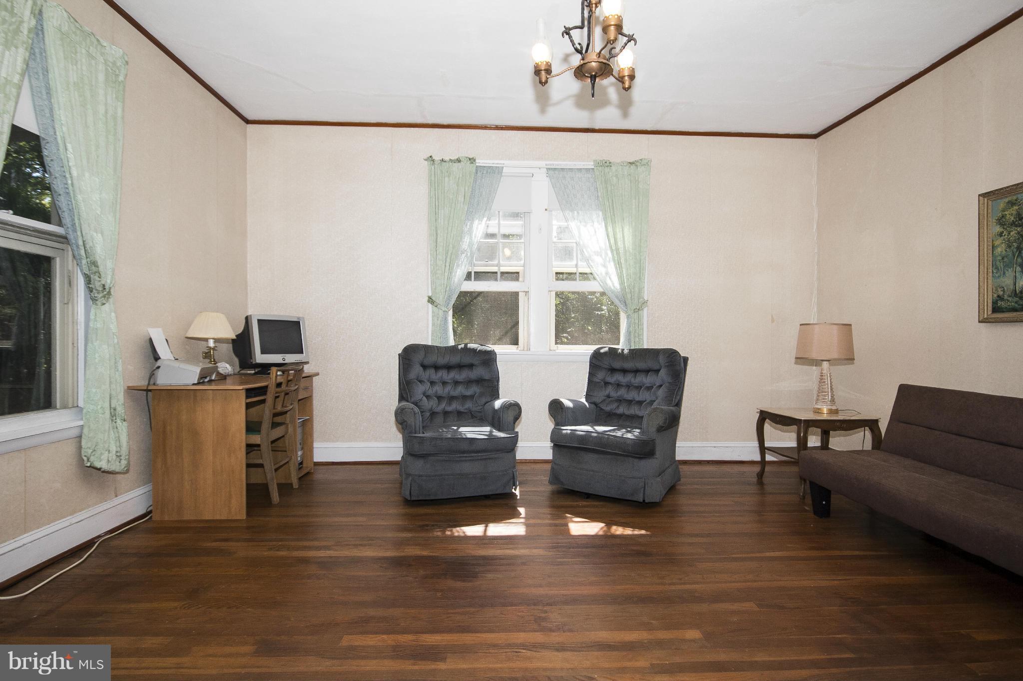 1554 South Rolling Road Baltimore, MD 21227 - Photo 3 of 22 a living room with furniture and a large window