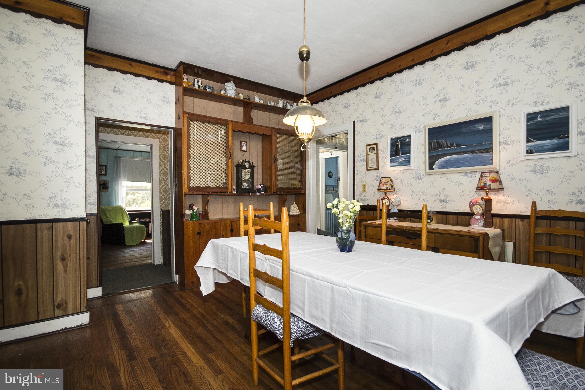 1554 South Rolling Road Baltimore, MD 21227 - Photo 7 of 22 a view of a dining room with furniture and wooden floor