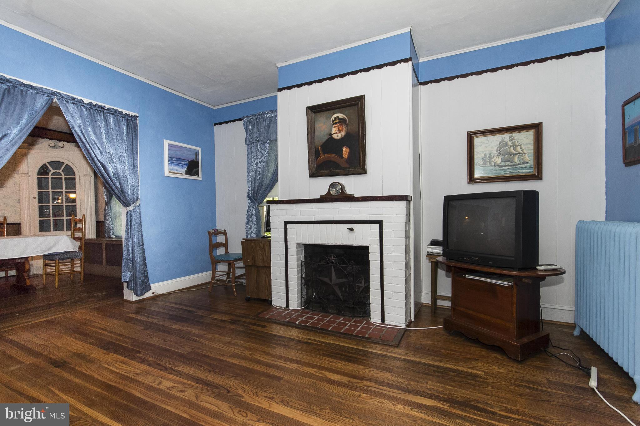 1554 South Rolling Road Baltimore, MD 21227 - Photo 8 of 22 a living room with furniture a flat screen tv and a fireplace