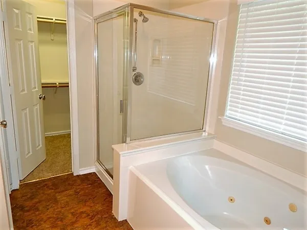 a bathroom with a bathtub and a shower