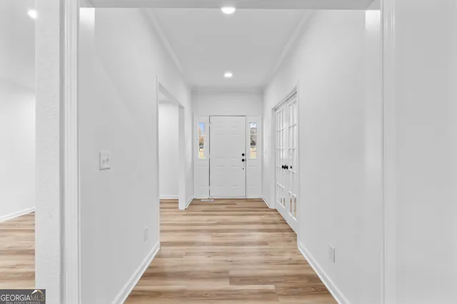 a view of a hallway with wooden floor