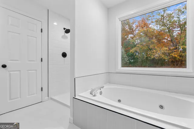 a bathroom with a tub and shower
