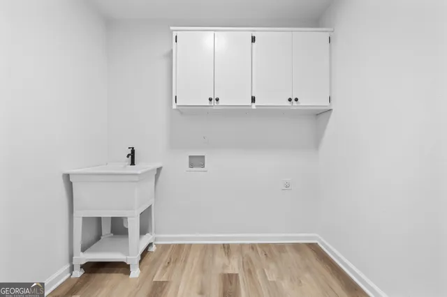 a view of storage and utility room with wooden floor