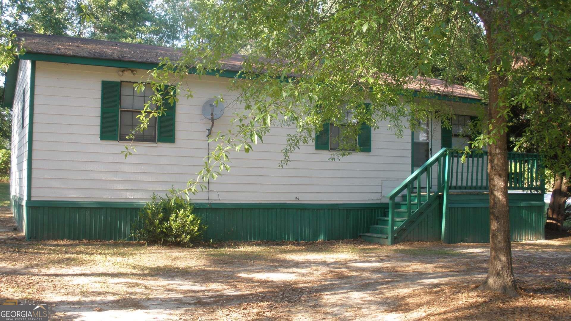 2 B & B Loop Road Butler, GA 31006 - Photo 1 of 1 a view of a house with a backyard