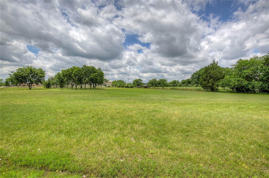 221 Maple Street Commerce, TX 75428 - Photo 13 of 19 a view of a green field and trees