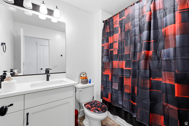 347 Ropelato Drive Logan, UT 84321 - Photo 31 of 46 Bathroom featuring a single vanity with an integrated sink, white countertop, and dark-finish faucet