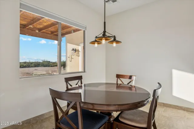 a view of a dining room with furniture window and outside view