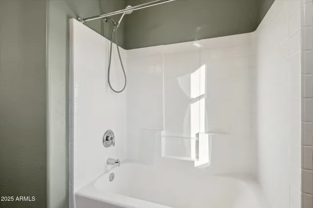 a bathroom with a bath tub and a shower