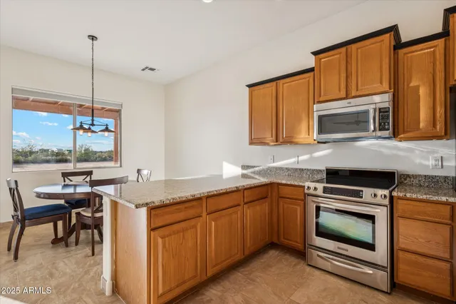 a kitchen with a stove sink and microwave