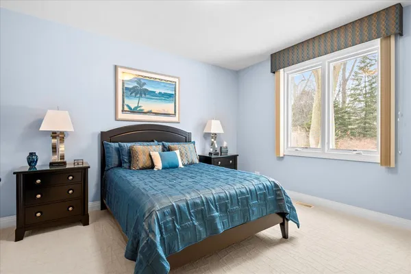 a bedroom with a bed a lamp and a window