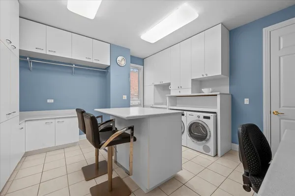 a utility room with cabinets dryer and washer