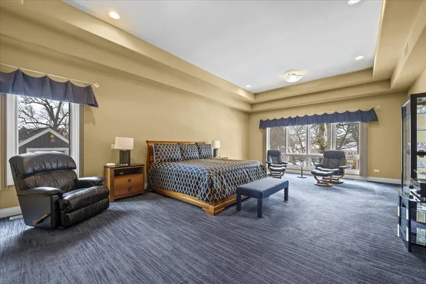 a bedroom with furniture and a large window
