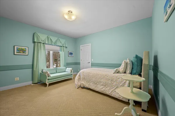 a bedroom with a bed and a mirror