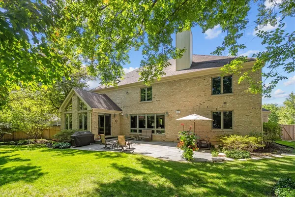 a view of a house with backyard porch and sitting area