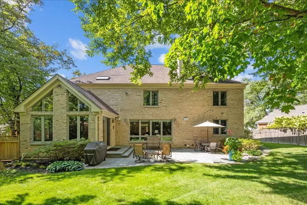 a front view of house with yard and outdoor seating