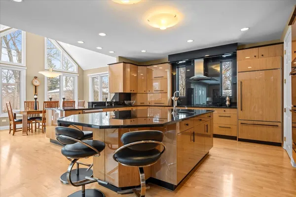 a large kitchen with kitchen island granite countertop lots of counter top space and stainless steel appliances