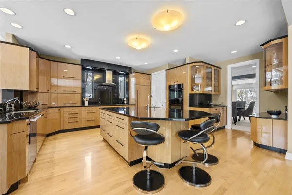 a kitchen with counter top space cabinets stainless steel appliances and furniture