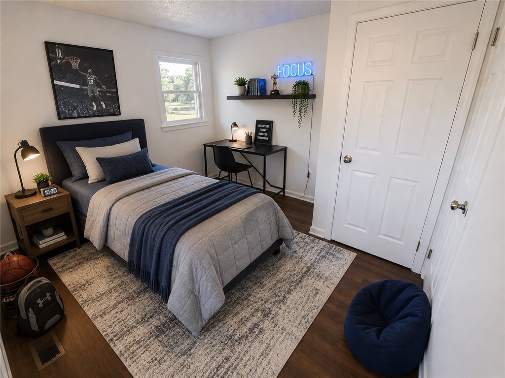 404 McClain Road Anderson, SC 29626 - Photo 24 of 24 This cozy bedroom features hardwood floors and a bright window overlooking the landscape.