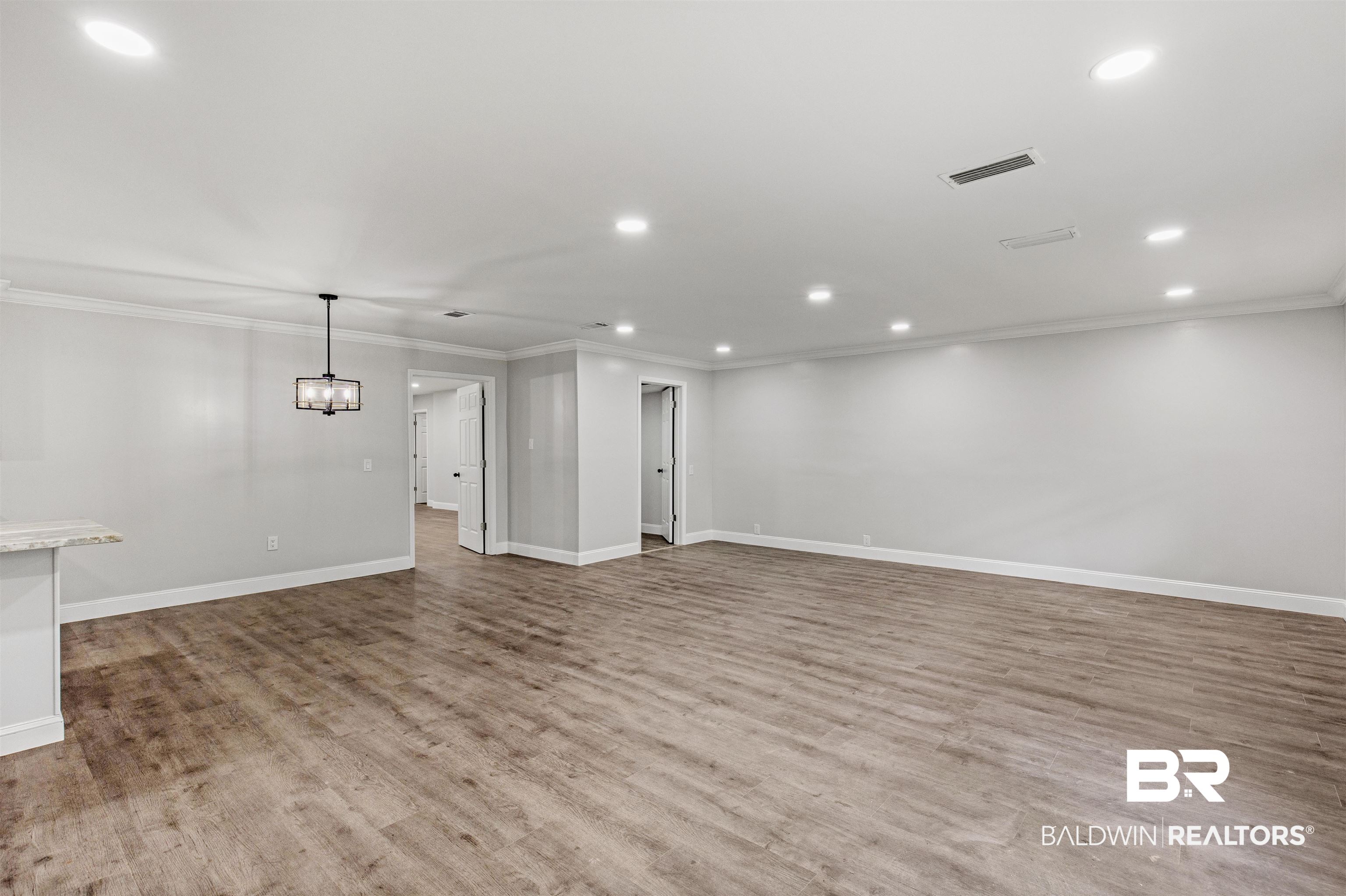 1432 South Polaris Drive Mobile, AL 36693 - Photo 4 of 27 Unfurnished living room with recessed lighting, crown molding, and wood finished floors