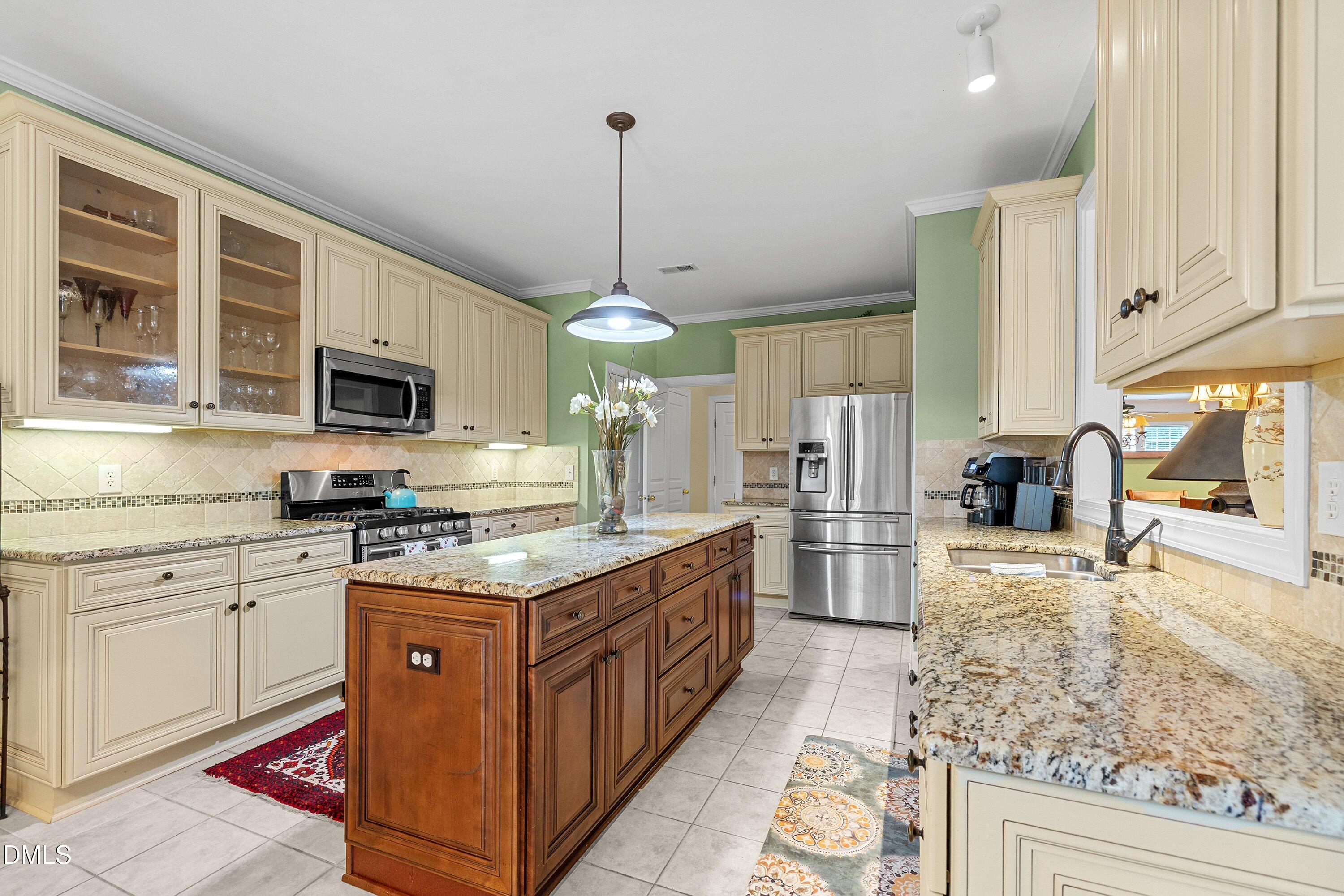 3613 Lion Ridge Court Raleigh, NC 27612 - Photo 13 of 40 a kitchen with stainless steel appliances granite countertop a stove oven and a refrigerator