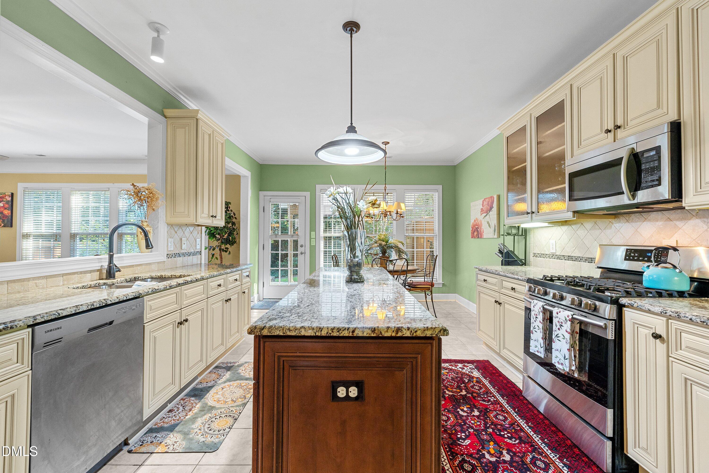 3613 Lion Ridge Court Raleigh, NC 27612 - Photo 14 of 40 a large kitchen with stainless steel appliances granite countertop a stove and a sink