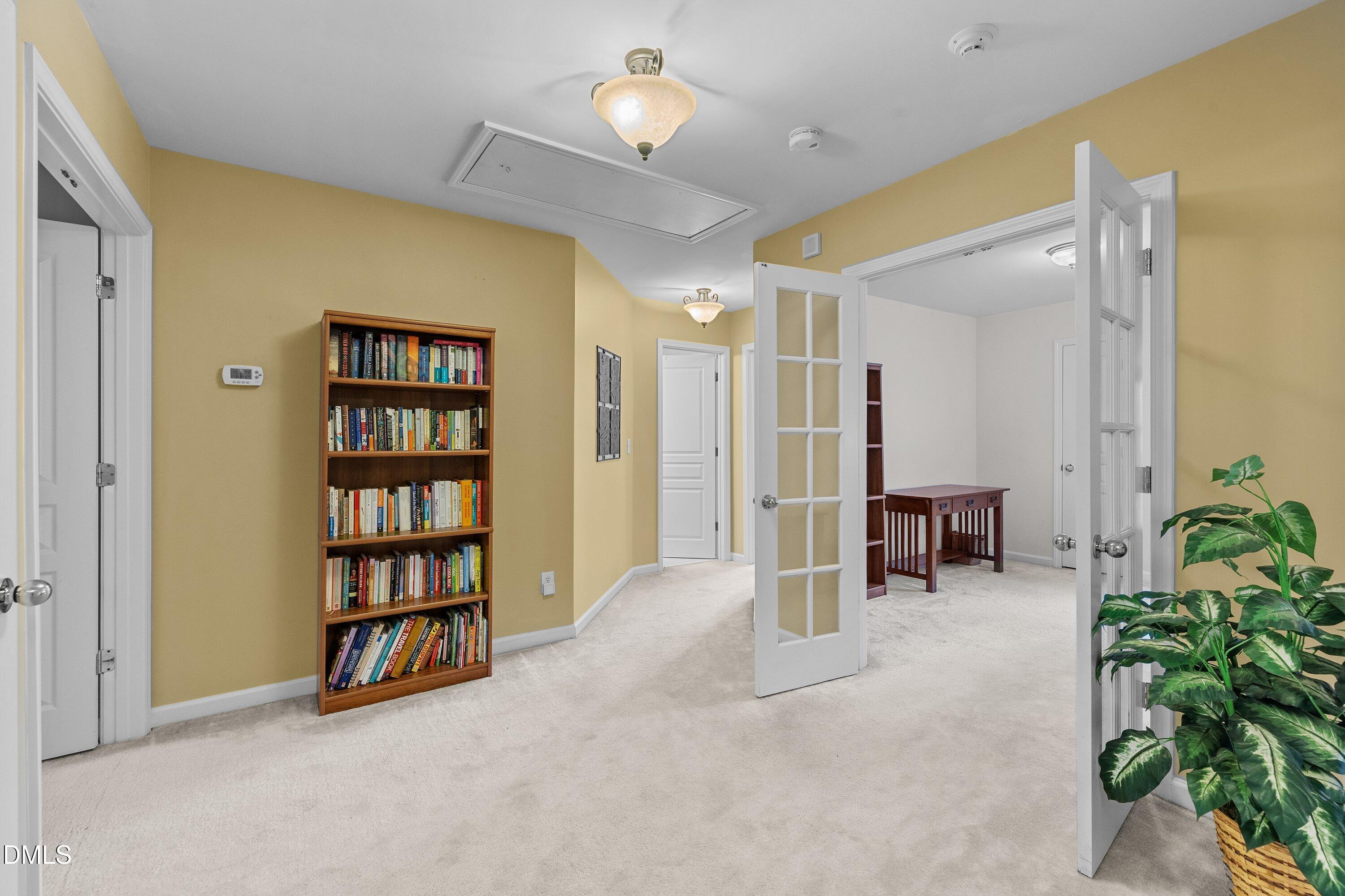 3613 Lion Ridge Court Raleigh, NC 27612 - Photo 19 of 40 a living room with furniture and a book shelf