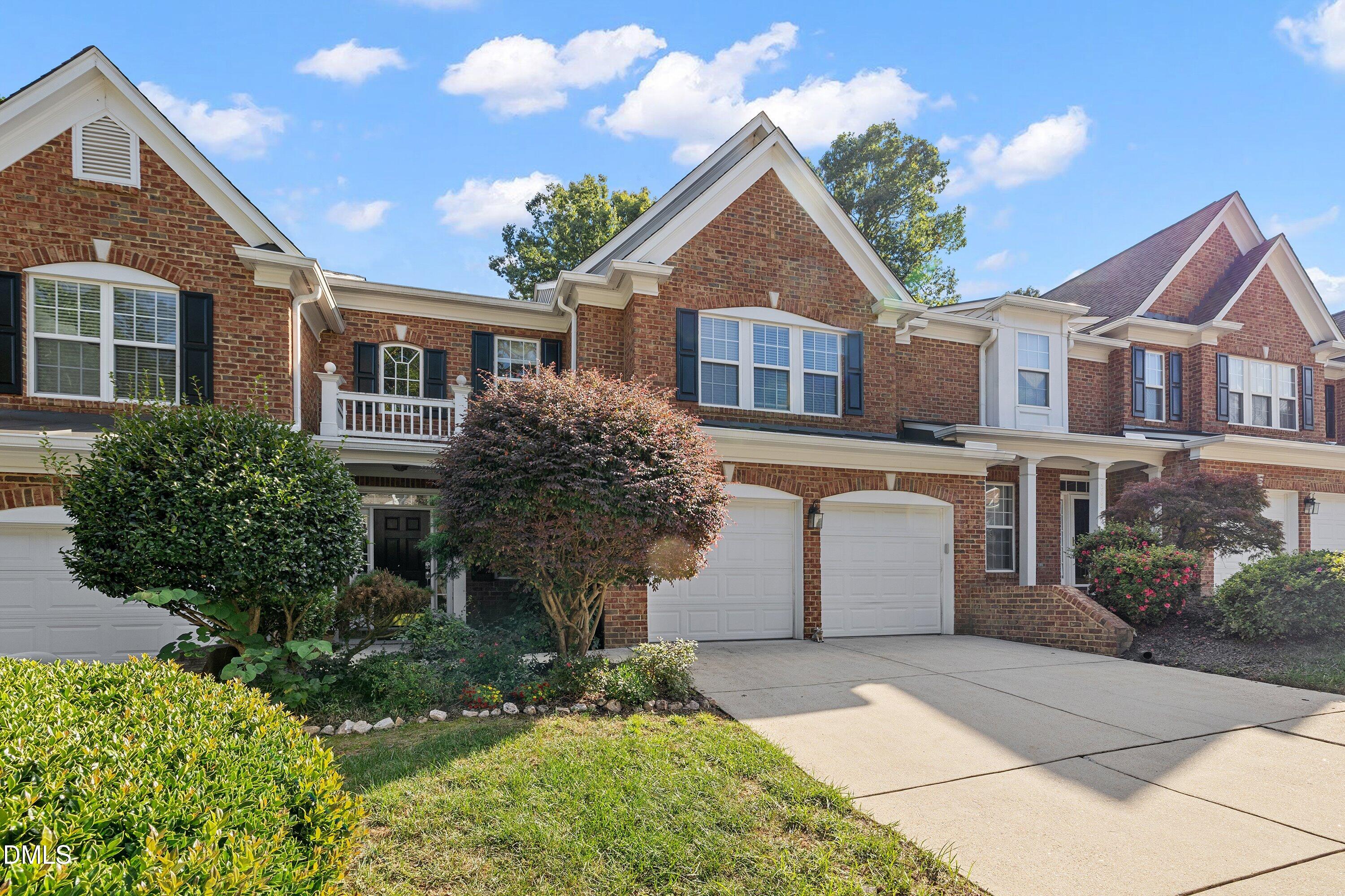 3613 Lion Ridge Court Raleigh, NC 27612 - Photo 2 of 40 a front view of a house with a yard and garage