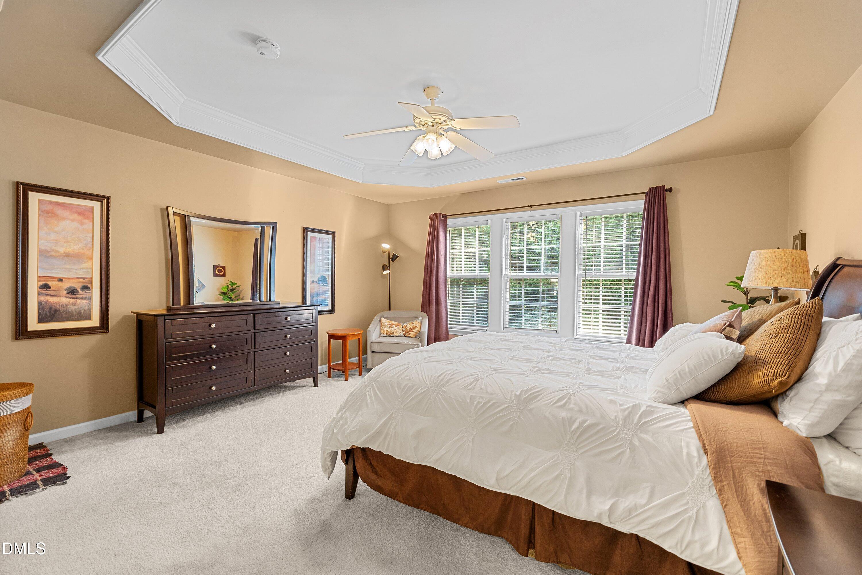 3613 Lion Ridge Court Raleigh, NC 27612 - Photo 27 of 40 a bedroom with a bed dresser and window