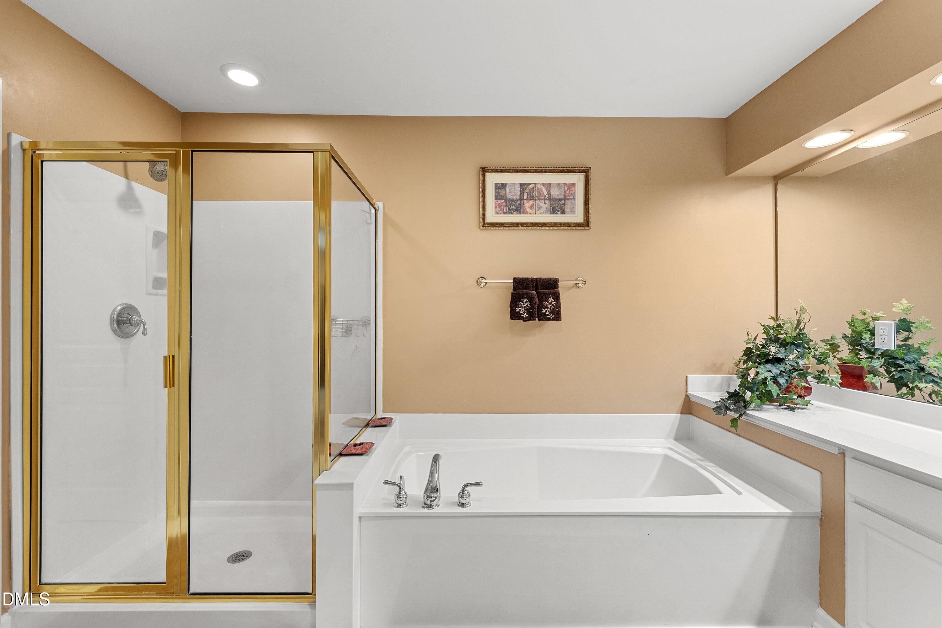 3613 Lion Ridge Court Raleigh, NC 27612 - Photo 30 of 40 a bathroom with a bathtub and a shower