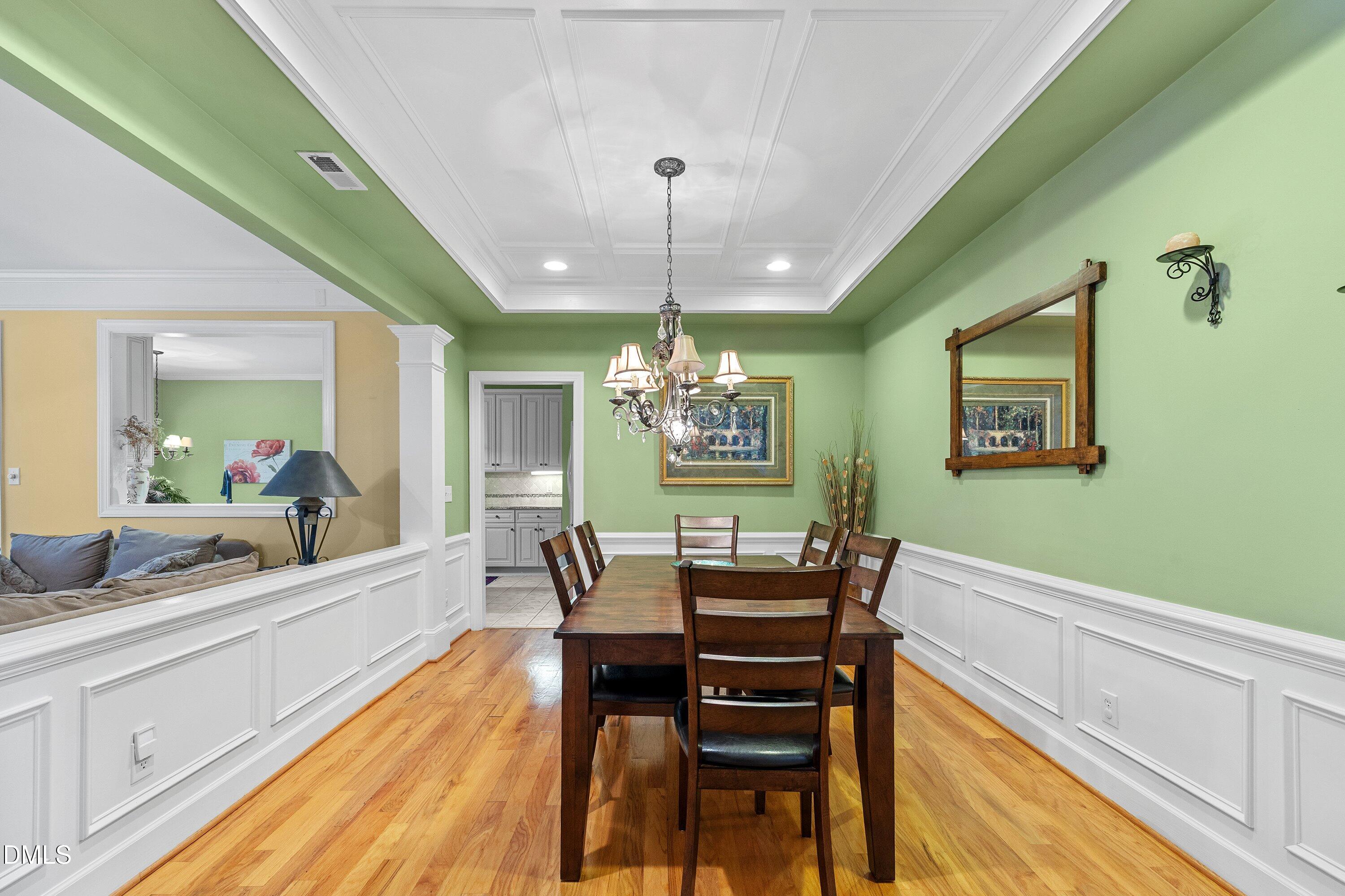 3613 Lion Ridge Court Raleigh, NC 27612 - Photo 7 of 40 a dining room with furniture a chandelier and wooden floor