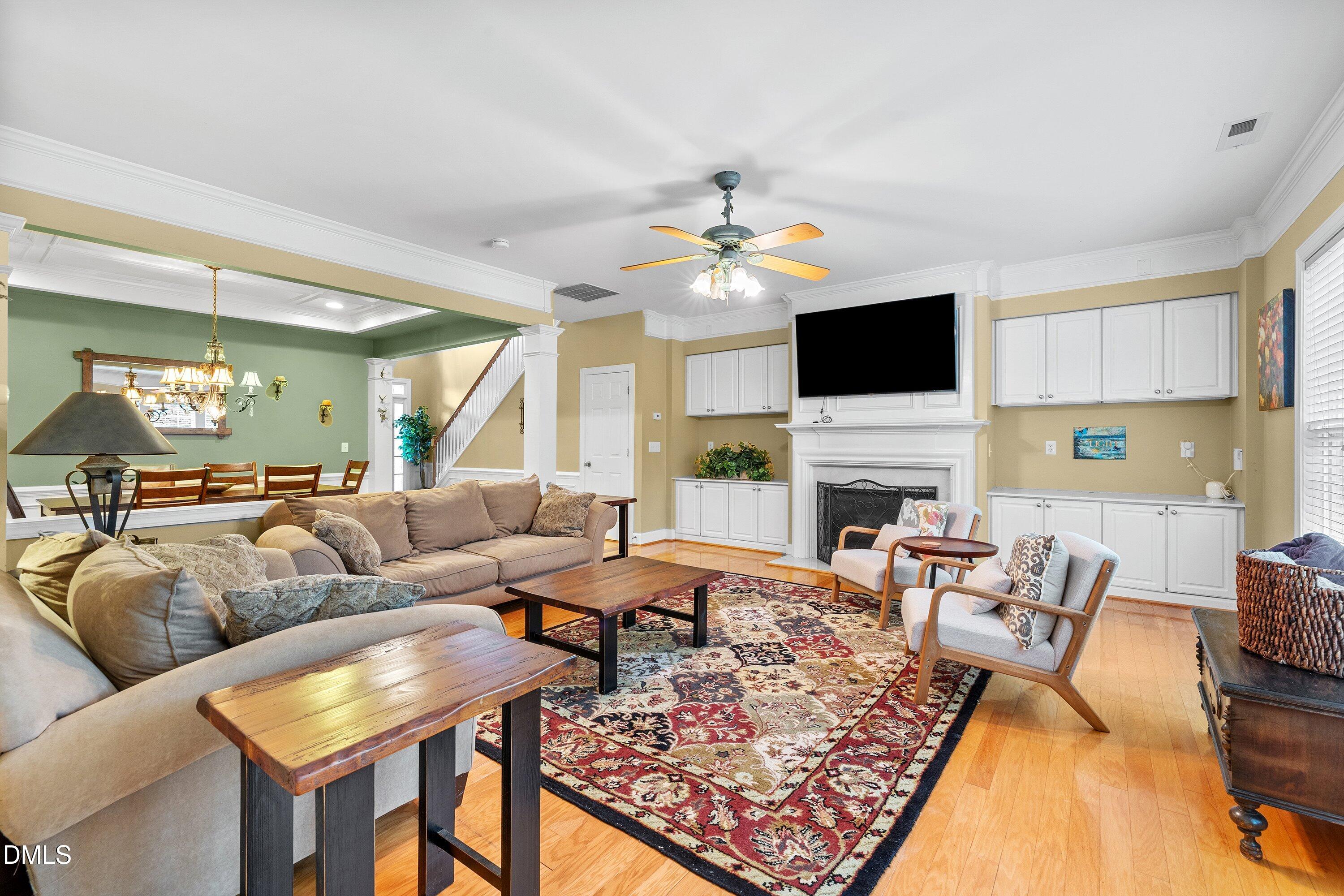 3613 Lion Ridge Court Raleigh, NC 27612 - Photo 9 of 40 a living room with furniture a fireplace and a flat screen tv