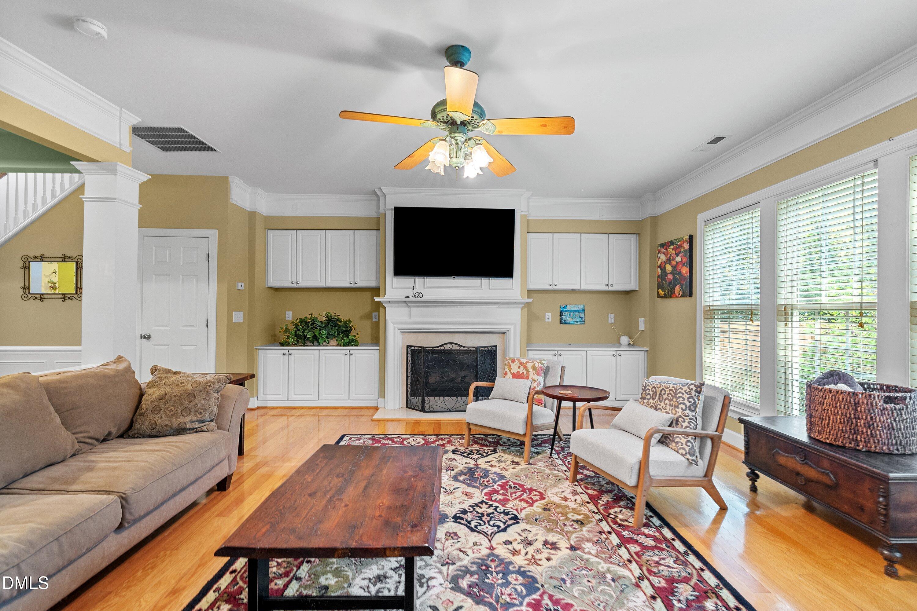 3613 Lion Ridge Court Raleigh, NC 27612 - Photo 10 of 40 a living room with furniture a fireplace and a flat screen tv