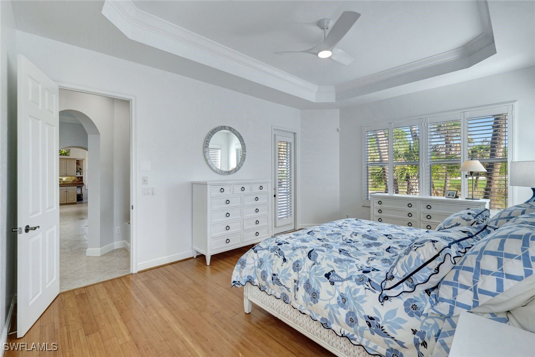 2450 Wulfert Road Sanibel, FL 33957 - Photo 26 of 44 a bedroom with a large bed and wooden floor