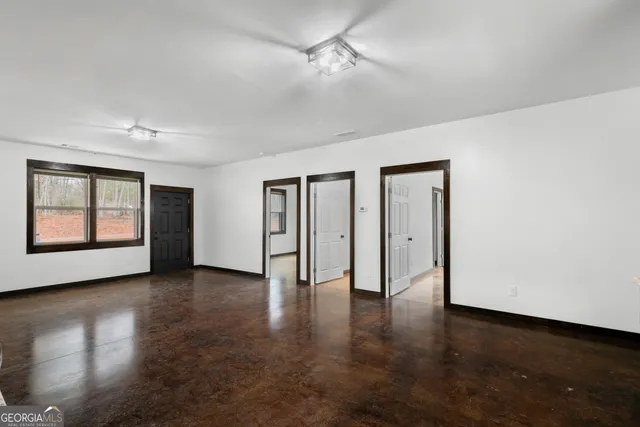 an empty room with windows and closet