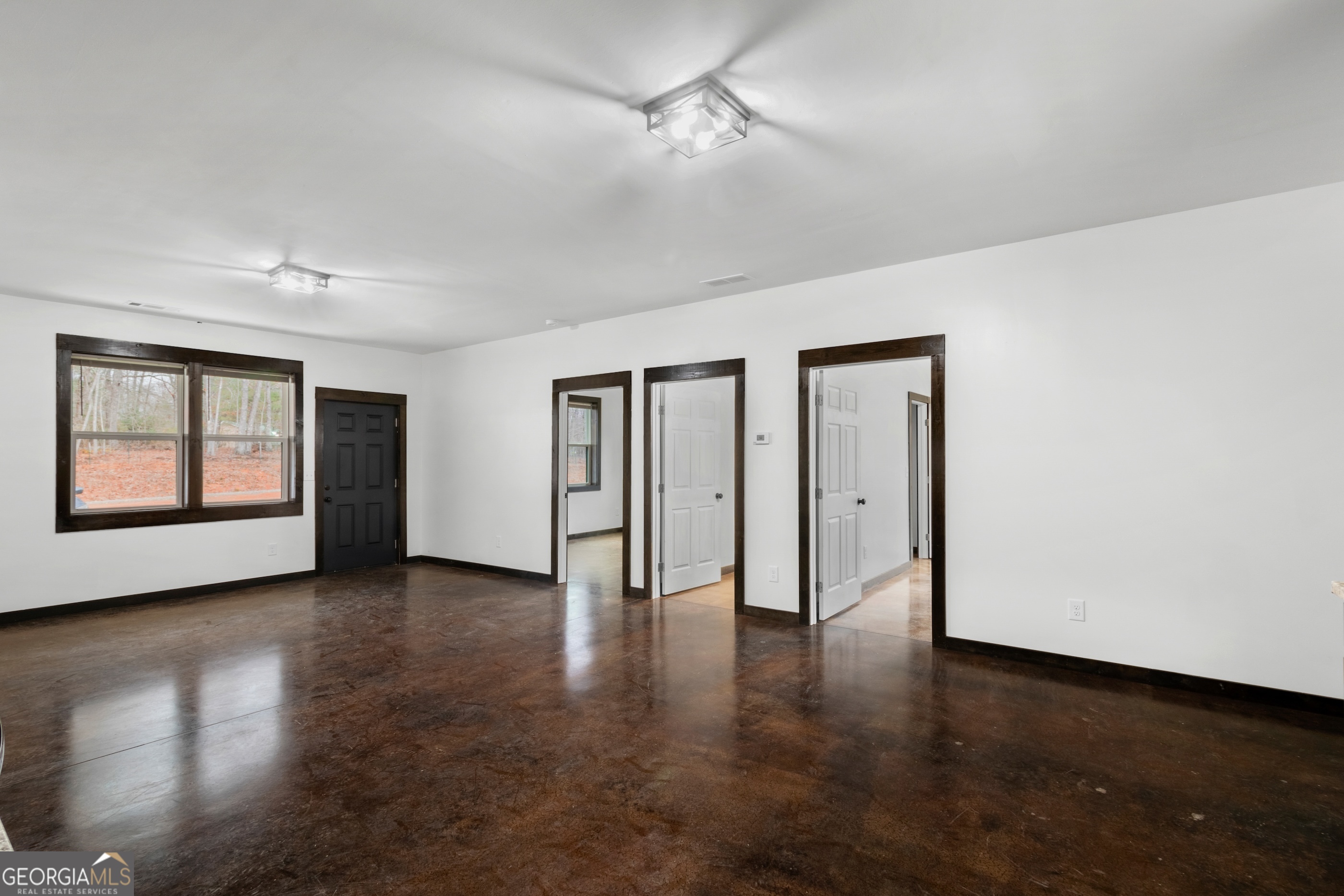 620 Stiles Road, Unit A Epworth, GA 30541 - Photo 11 of 21 a view of an empty room with a window and wooden floor