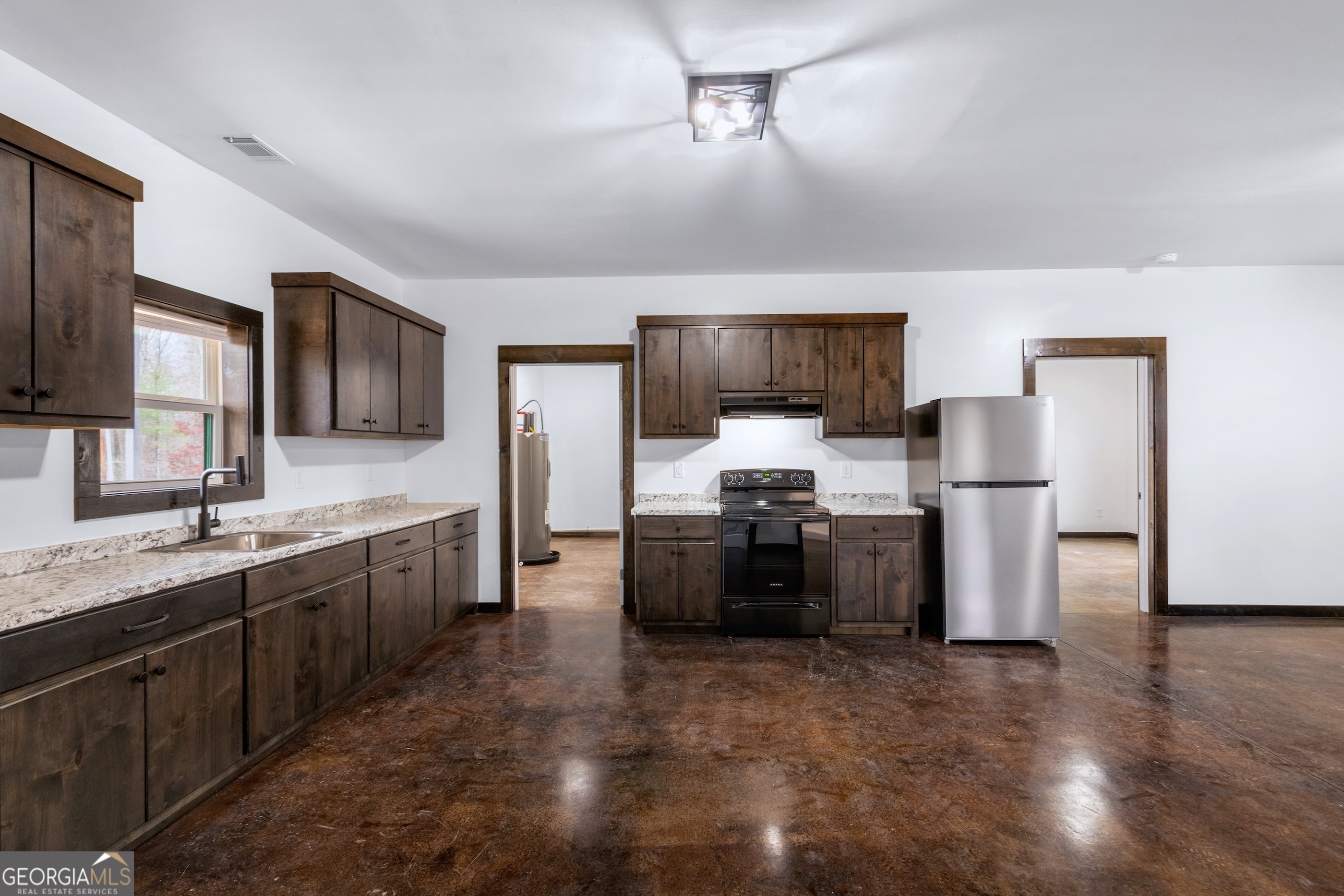 620 Stiles Road, Unit A Epworth, GA 30541 - Photo 19 of 21 a large kitchen with a stove a sink dishwasher a refrigerator and a oven with wooden floor