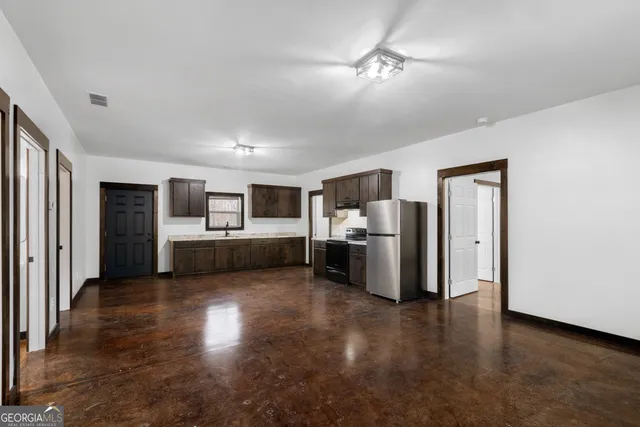 a view of a kitchen with refrigerator and microwave