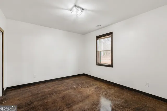 an empty room with closet area