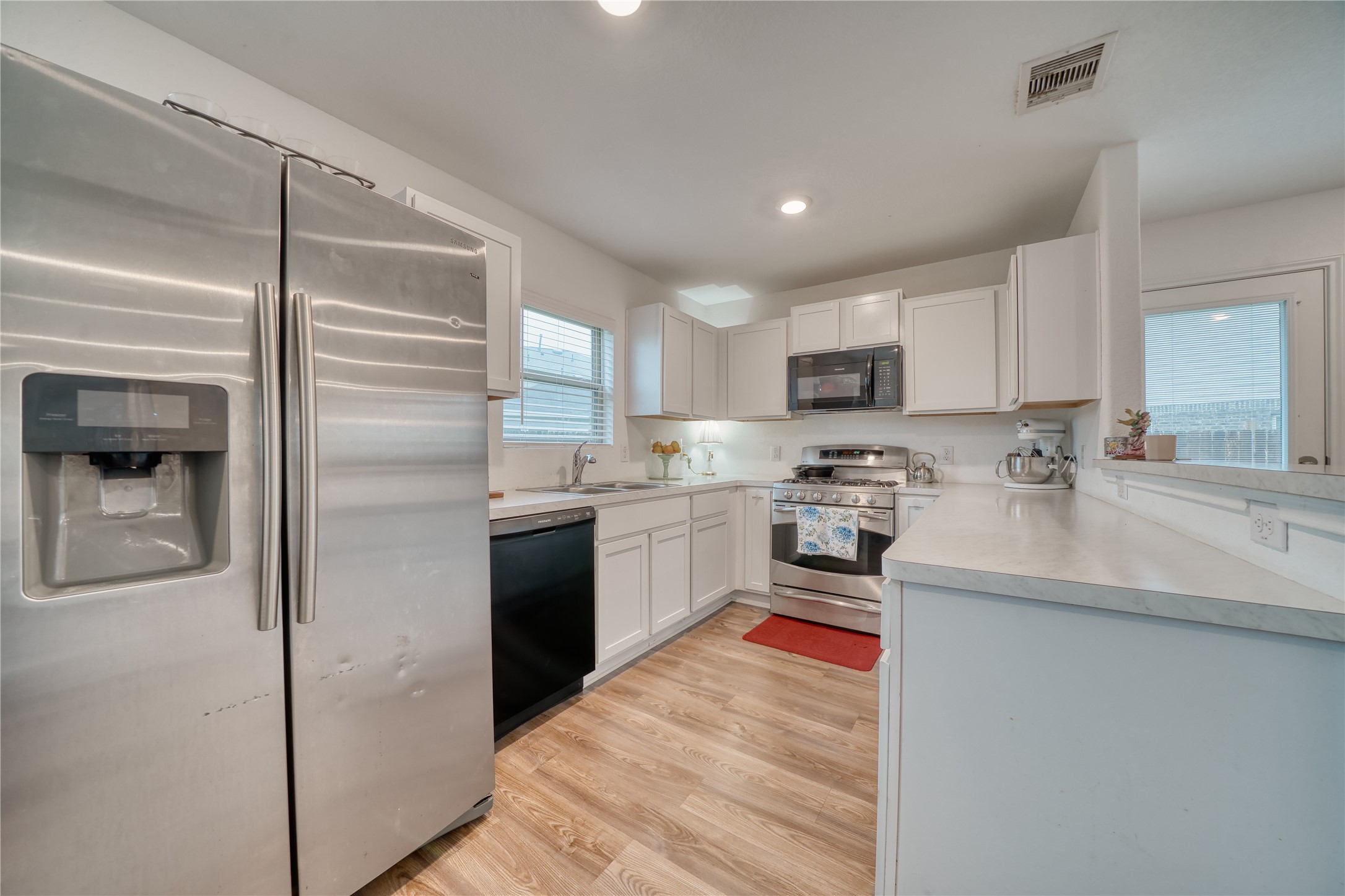 184 Kelly Street Angleton, TX 77515 - Photo 7 of 19 The heart of the home! This open-concept kitchen looks out over the living areas, keeping you connected while you cook. Plenty of counter space and a gas range make meal prep a breeze.