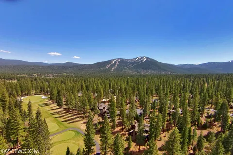 a view of a yard with furniture and a garden