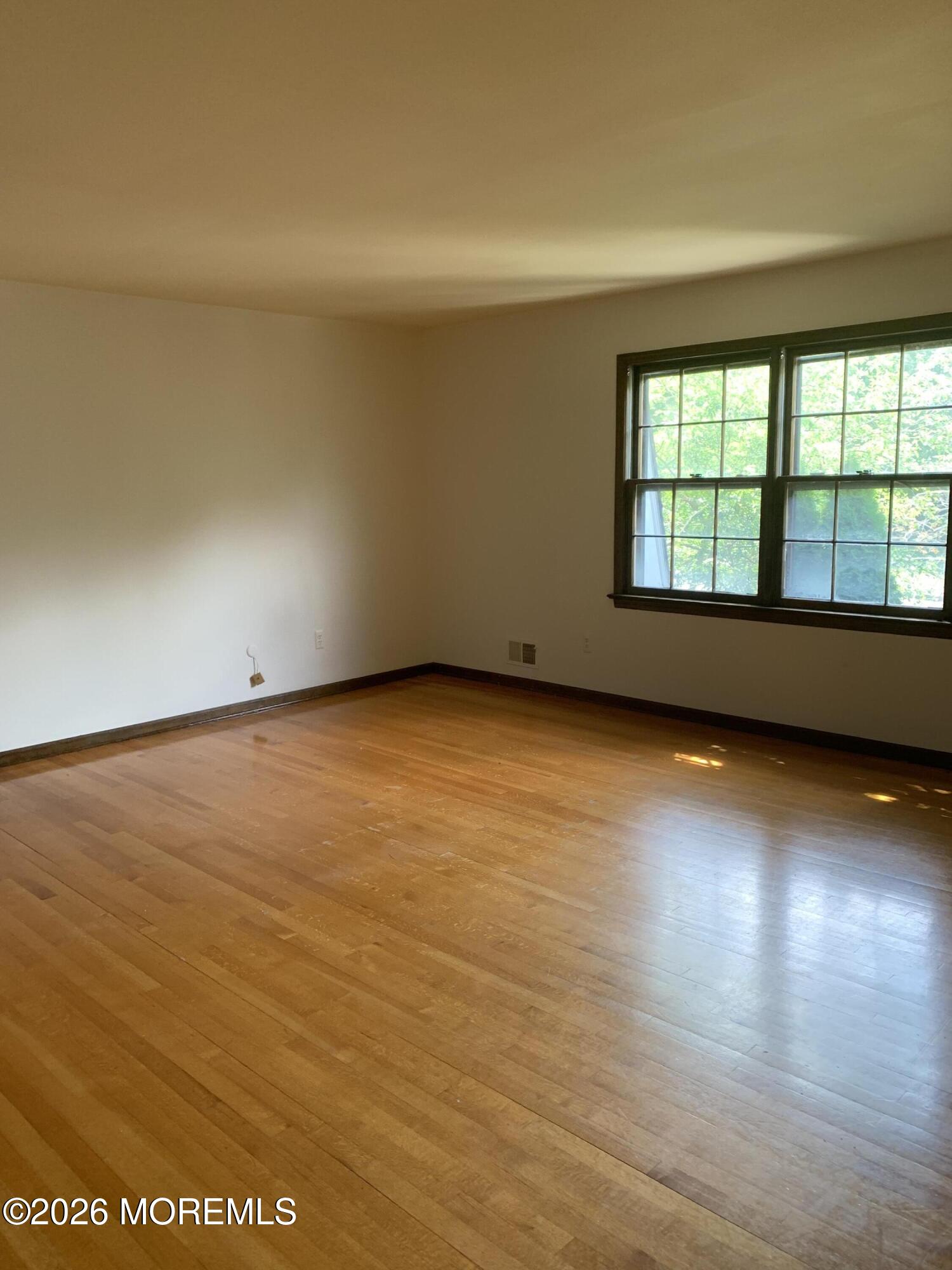 2 Carbury Road Asbury Park, NJ 07712 - Photo 13 of 21 a view of an empty room with wooden floor and a window