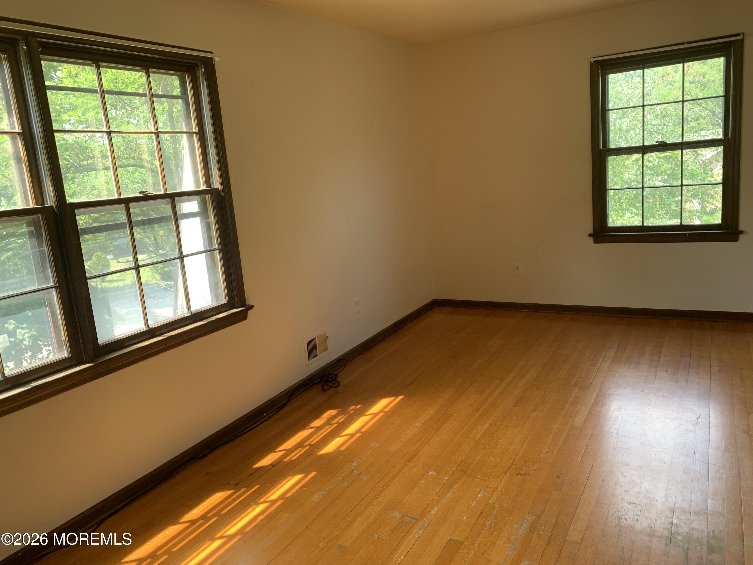 2 Carbury Road Asbury Park, NJ 07712 - Photo 15 of 21 an empty room with wooden floor and windows