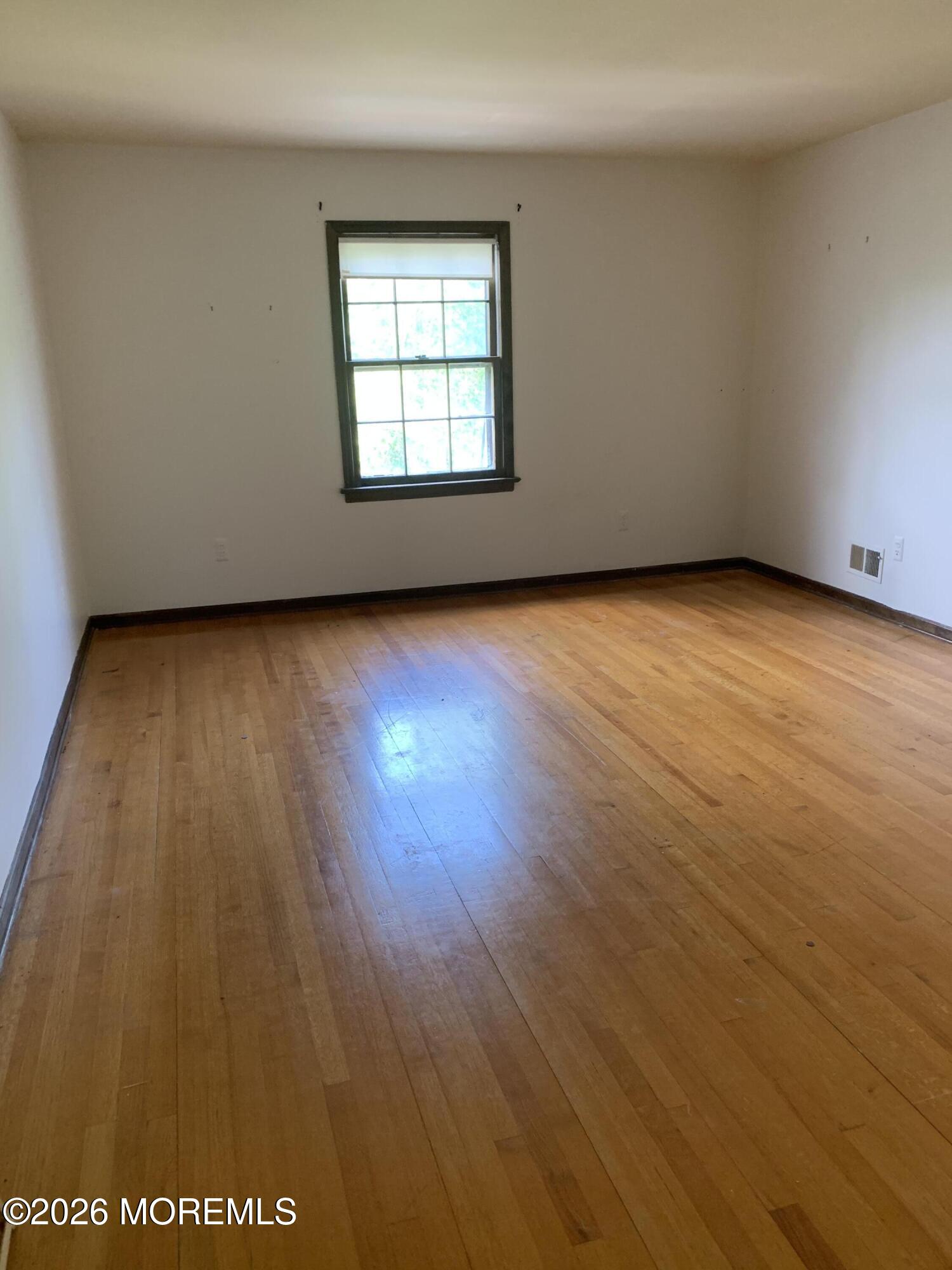 2 Carbury Road Asbury Park, NJ 07712 - Photo 17 of 21 an empty room with wooden floor and windows