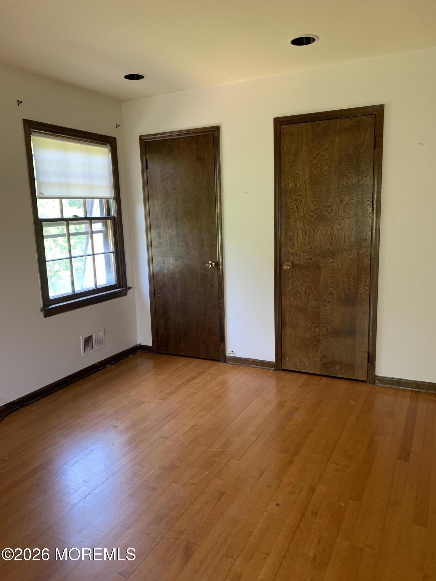 2 Carbury Road Asbury Park, NJ 07712 - Photo 19 of 21 an empty room with windows and closet