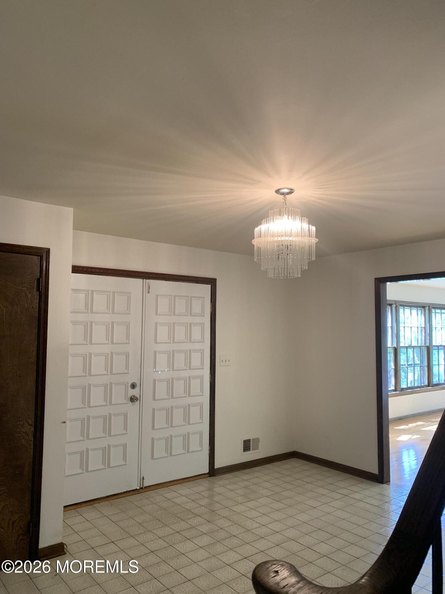 2 Carbury Road Asbury Park, NJ 07712 - Photo 3 of 21 a view of an empty room with wooden floor and a window