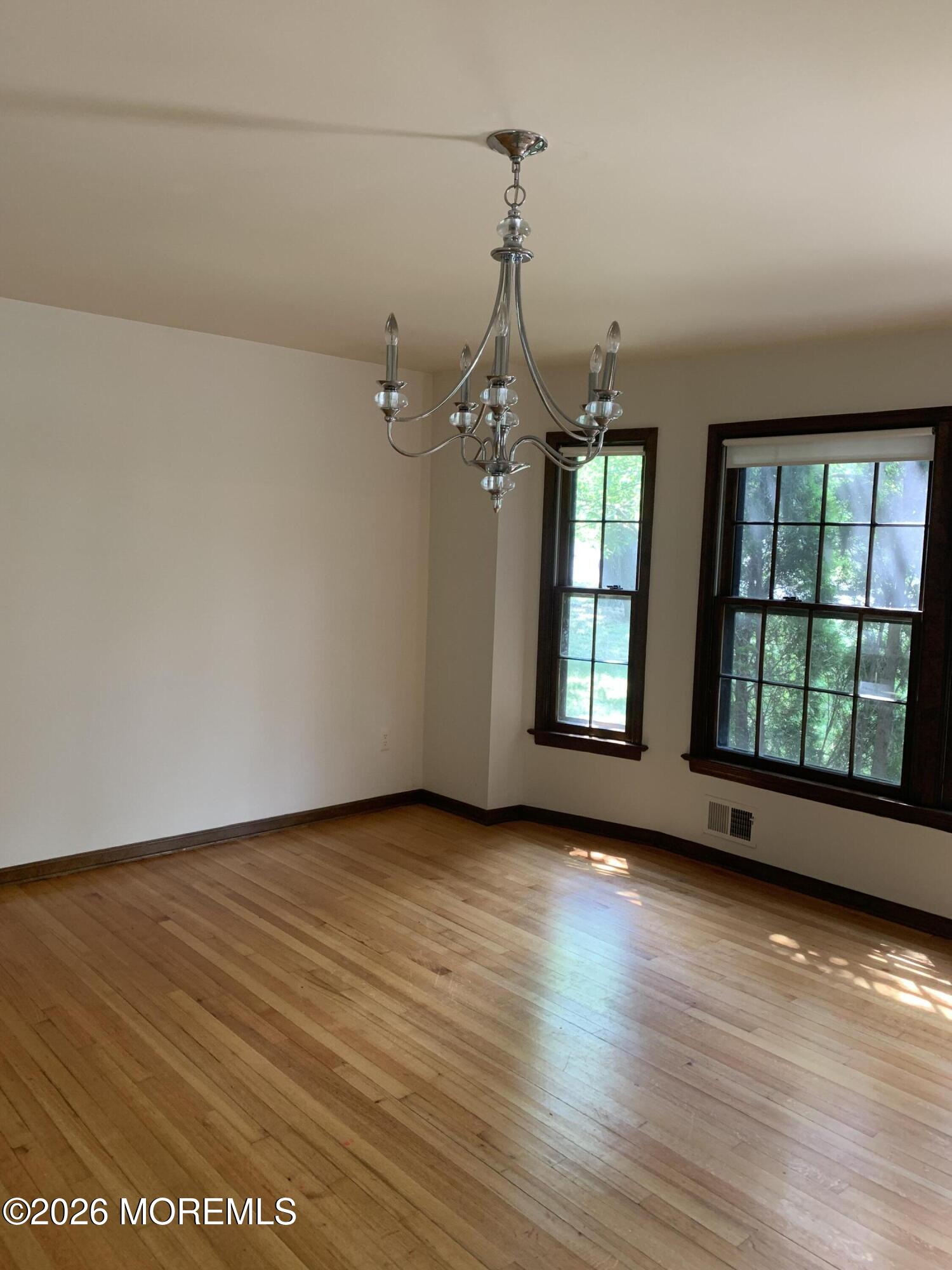 2 Carbury Road Asbury Park, NJ 07712 - Photo 6 of 21 a view of an empty room with wooden floor and a window