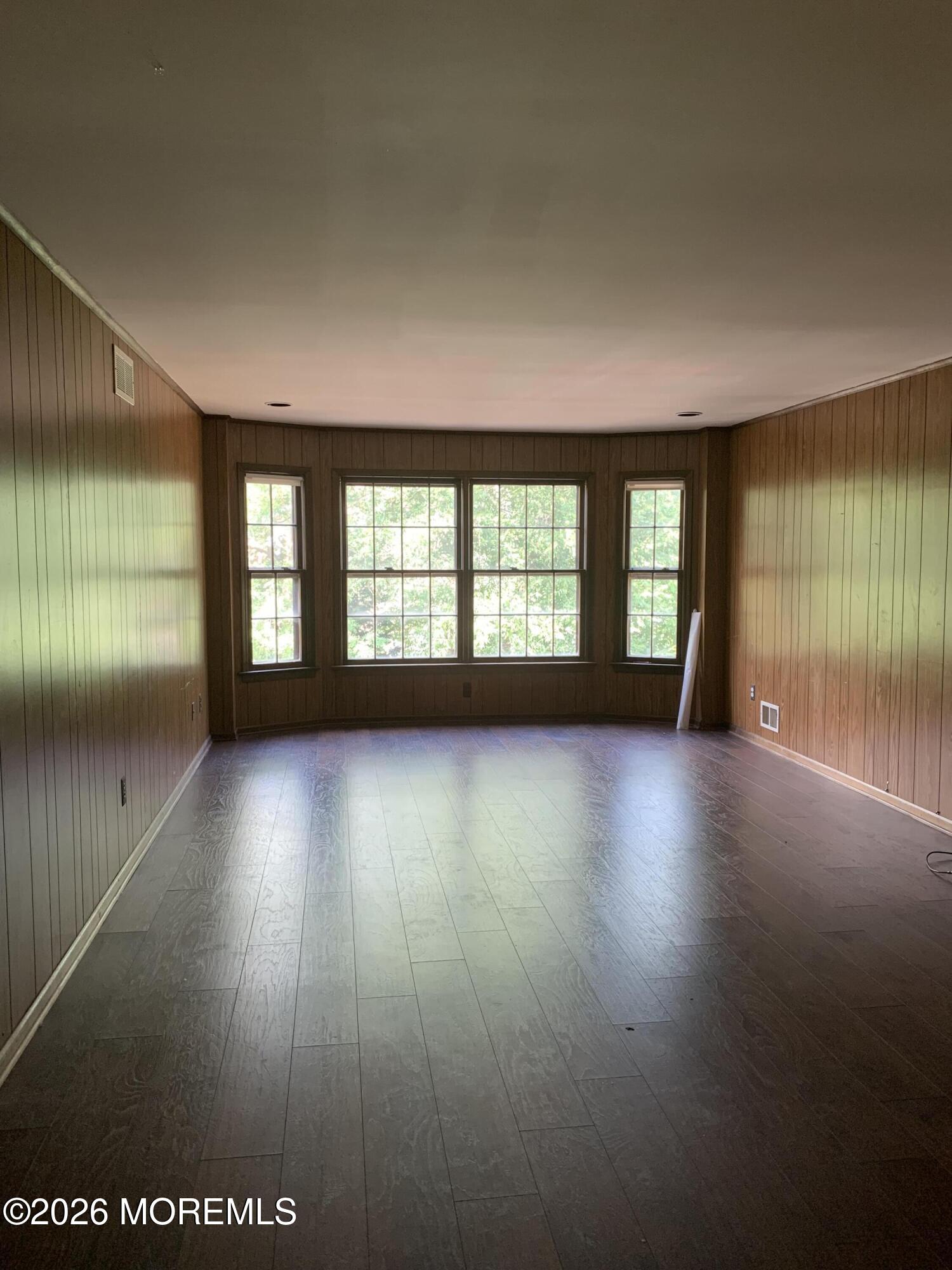 2 Carbury Road Asbury Park, NJ 07712 - Photo 7 of 21 an empty room with wooden floor and windows