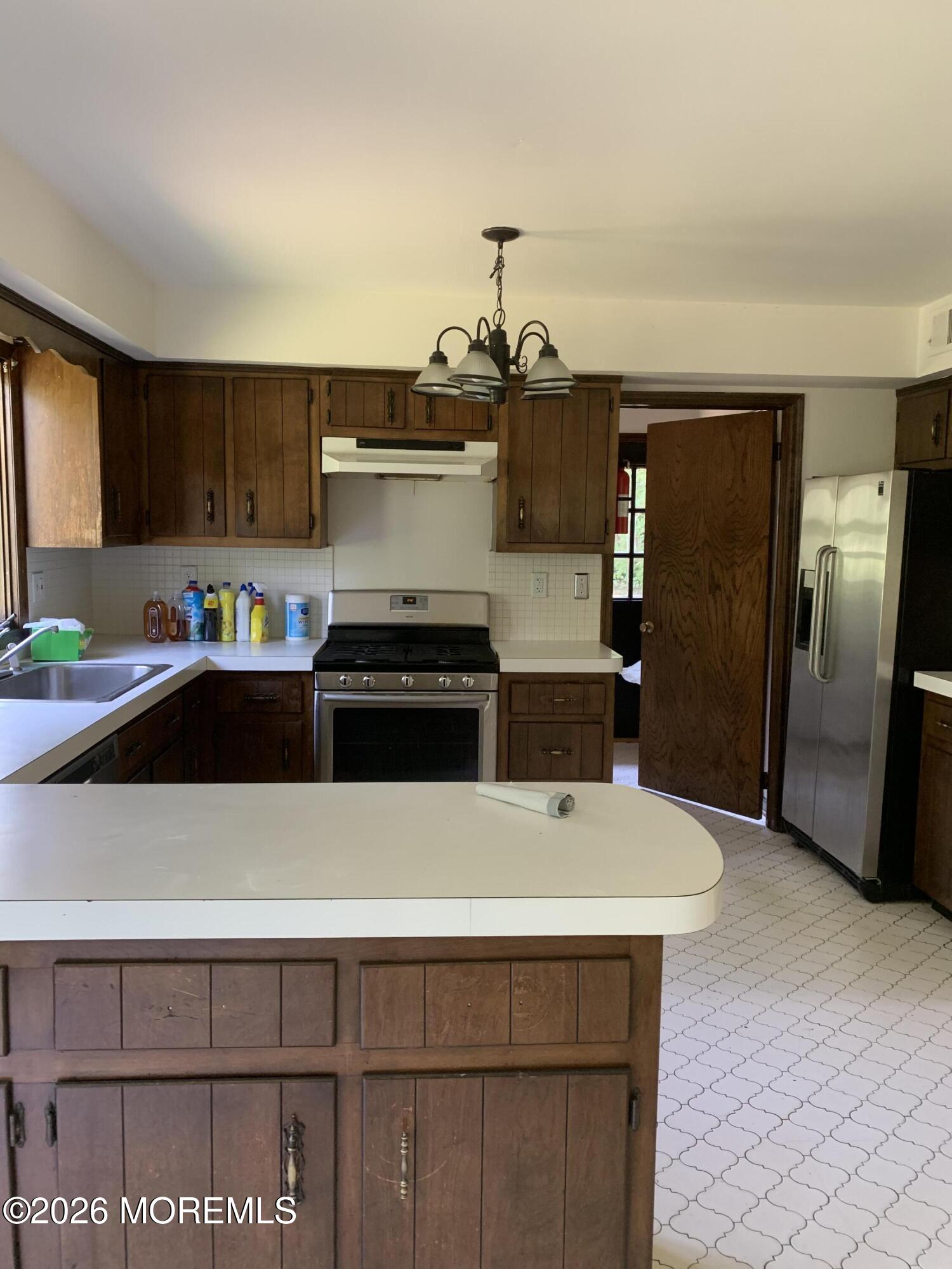 2 Carbury Road Asbury Park, NJ 07712 - Photo 10 of 21 a kitchen with stainless steel appliances a sink and a refrigerator