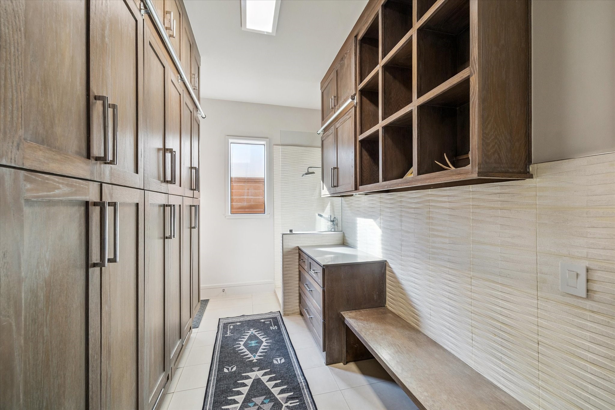 1249 Chippendale Road Houston, TX 77018 - Photo 33 of 45 Well equipped mud room as you enter from garage, with large storage lockers. Lockers have power strips for charging your accessories. To the back right, a dog shower, opposite a dog door.